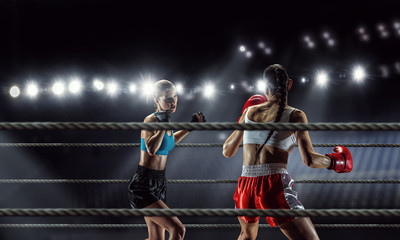 Fototapeta na wymiar Girls boxing in ring . Mixed media