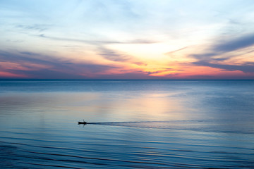 Beautiful sunrise with Thai fishing boats in the sea