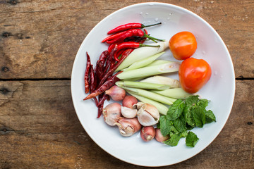 Spices and herbs in a white dish. Table Brown