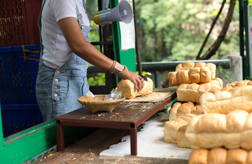 Woman slicing cutting soft bread for feeding fish