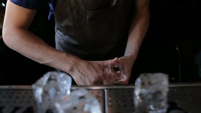 Bartender mannually crushed ice with knife.