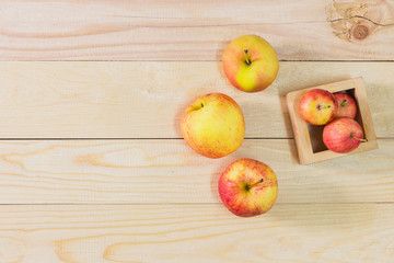 Fresh Apples in a wooden crate on wooden table background