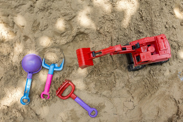 Fototapeta na wymiar toy trucks on sand playground