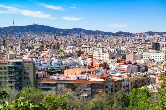 Cityscape / panoramic view of Barcelona and the Tibidabo Mount with the television tower Torre de Collserola and the Expiatory Church of the Sacred Heart of Jesus on it