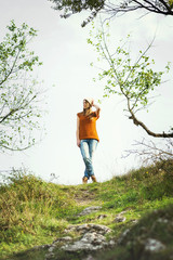 Modern young woman in park in autumn