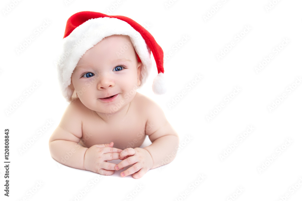 Wall mural christmas cute baby boy or girl lying on white like on snowdrift, beautiful funny infant in santa's 