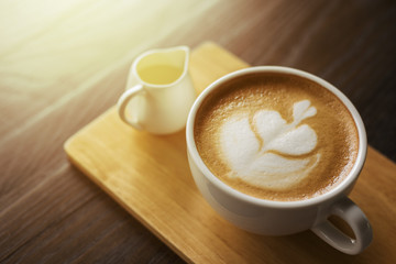 Hot latte art on wood table