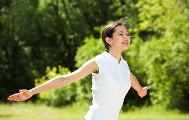 Portrait of enjoying woman raising her hands