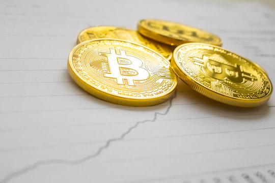 A golden bitcoin on graph background. trading concept of crypto currency