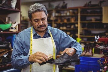 Shoemaker polishing a shoe 