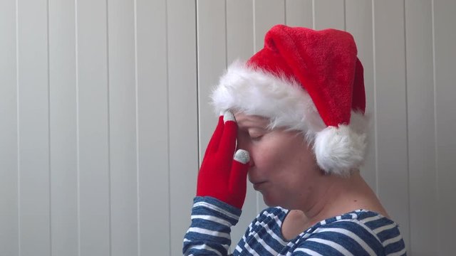 Disappointed woman with Christmas Santa Claus hat suffering from holiday depression, sad and lonely woman waiting New Year all let down
