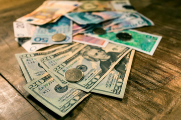 Fototapeta na wymiar Variable banknotes on wooden table, currency exchange