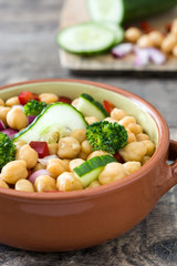 Chickpea salad on in bowl wooden background

