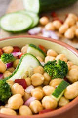 Chickpea salad on in bowl wooden background

