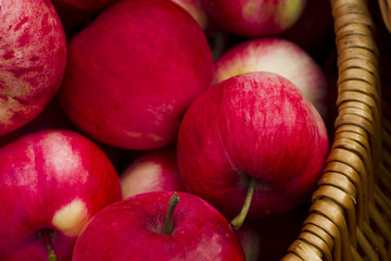Red apples in wooden wicker basket