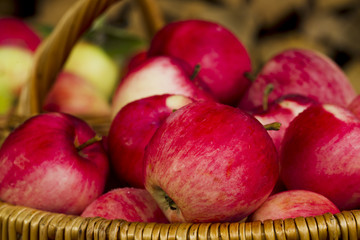 Red apples in wooden wicker basket