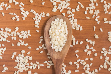 White grated corn kernels into a bowl