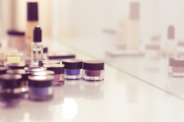 Make up tools on the white table. Eyeshadow, blush, concealer, p