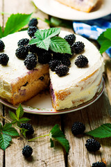 Honey cake with blackberry and whipped cream.