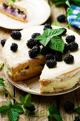 Honey cake with blackberry and whipped cream.