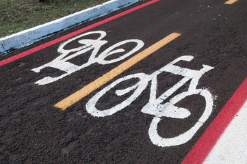 Obraz premium Signs on the ground for cyclists. bike lane track. Right to come and go cycling only. Exclusive lane for cyclists.