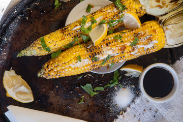 grilled corn on with lemon, herbs and spices