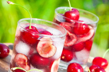 Ice cold cherry drink in glass outdoors