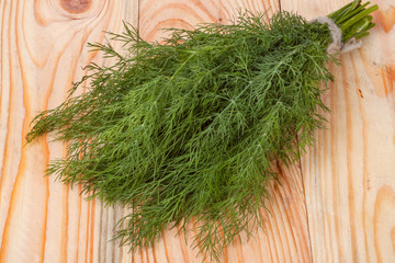 bunch of dill on wooden background