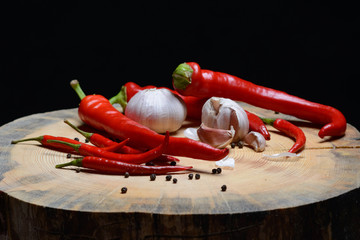 Red chilli papper and garlic on wood texture background
