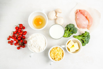 The selection of ingredients for the preparation of traditional French dishes quiche lorraine, on white wooden table, top view, copy space