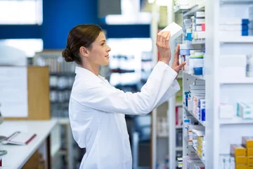 Wall murals Pharmacy Pharmacist checking medicine in shelf