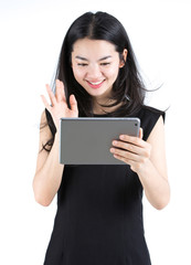 Naklejka premium Asian lady chatting using a tablet