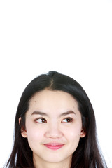 An asian woman thinking and smiling at the same time