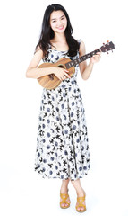 Attractive asian girl playing ukulele