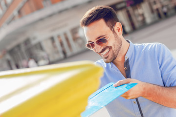 Man sending mail in the city