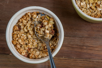 Freshly made autumn apple crumble on a wooden table, top view