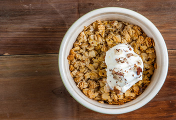 Freshly made autumn apple crumble on a wooden table, top view
