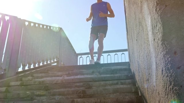 Man Jogging Up Sunny Stairs. Lens Flare. Close Up