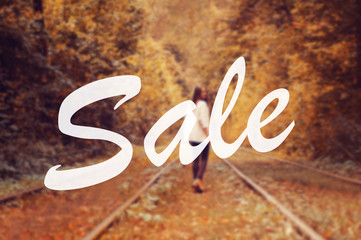 blurred natural autumn background with text Sale and beautiful girl