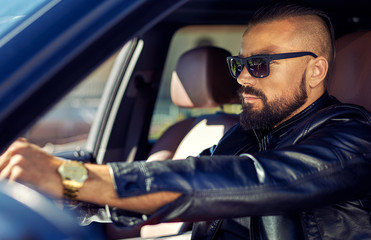 Fashion portrait of stylish young man in the car