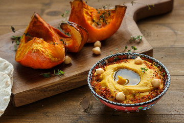 Pumpkin hummus and roasted butternut squash on background