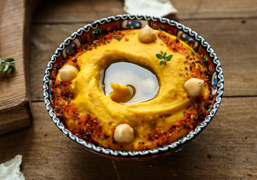 pumpkin thume hummus on a white wood background. the toning. selective focus, close view.