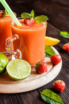 Energizing smoothie with mango, strawberries and lime in a glass jar