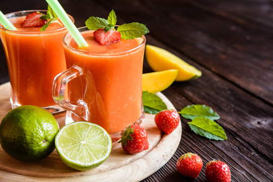 Energizing smoothie with mango, strawberries and lime in a glass jar