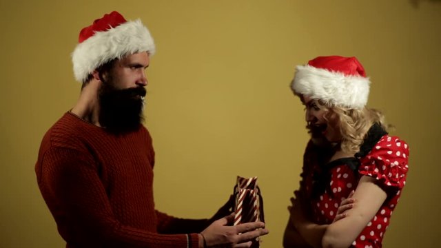 Boy is giving a Christmas present to a girl