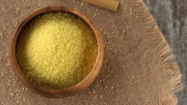 Raw couscous on burlap rotating. Seamless loopable. 4K