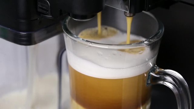 Process of making coffee in espresso machine. Ready coffee dropping at mug 
