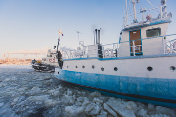 Naklejka premium The Icebreaker ship trapped in ice tries to break and leave the