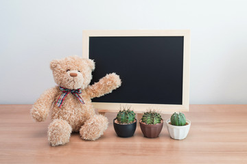 blank blackboard and teddy bear