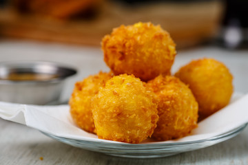 Lay the croquettes on a plate with red sauce. Big.